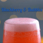 Blackberry & bubbles cocktail in champagne flute